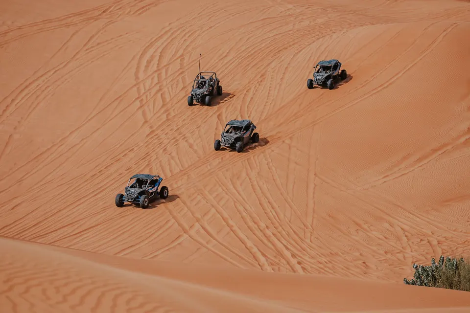Group of dune buggies crossing desert terrain
